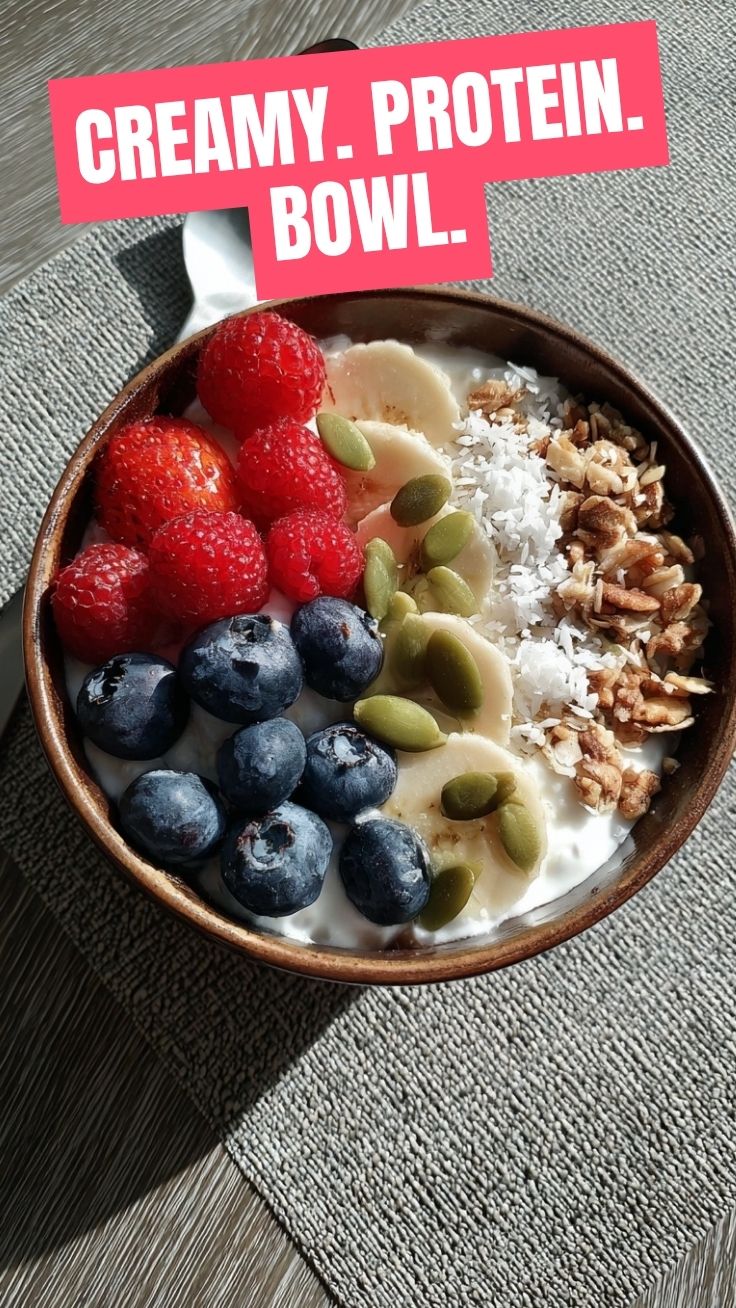 A bowl of high protein cottage cheese topped with fresh berries and nuts.