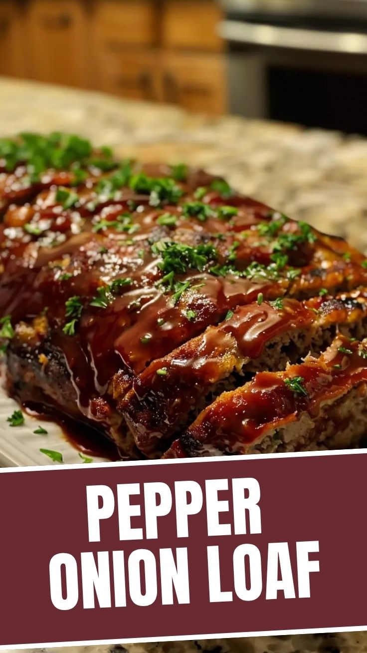 A well-browned and savory meatloaf, perfectly sliced and ready to serve.