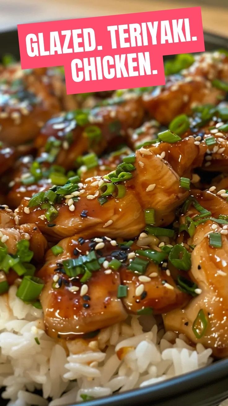 A plate of glistening teriyaki chicken, garnished with sesame seeds.