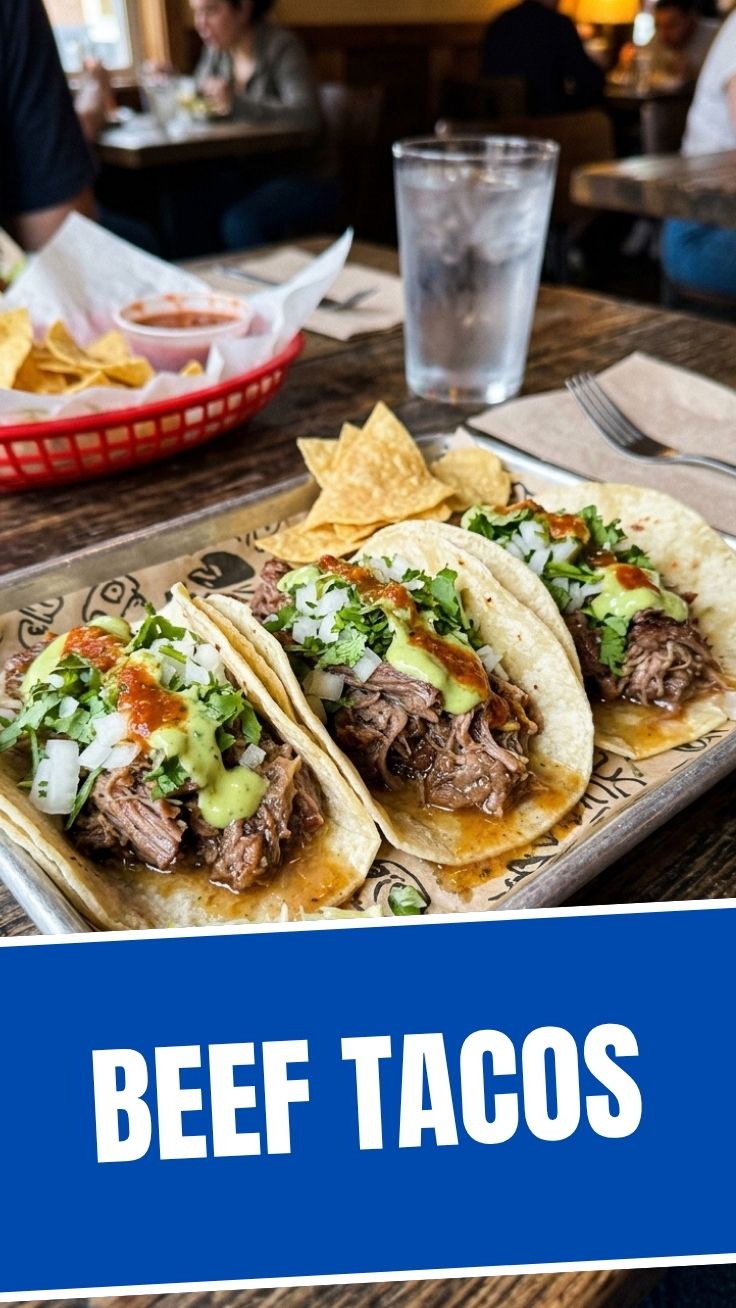 Close-up of three delicious beef tacos with fresh toppings